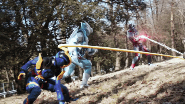 a man in a blue suit is fighting another man in a red suit with a sword