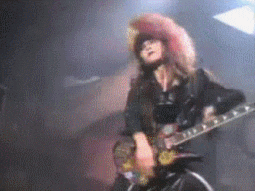 a blurry picture of a woman playing a guitar