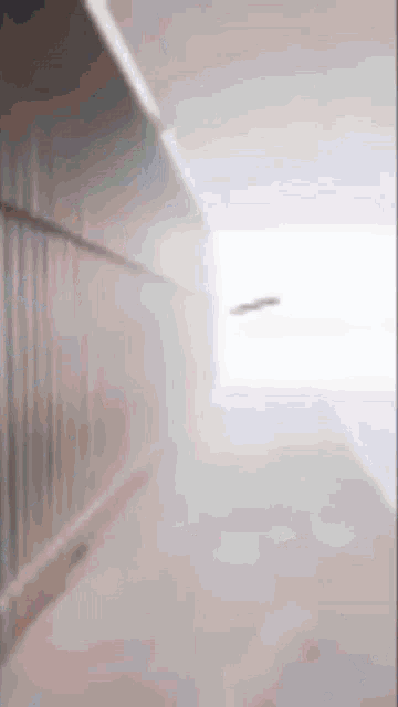 a blurred image of a hallway with a light coming out of it