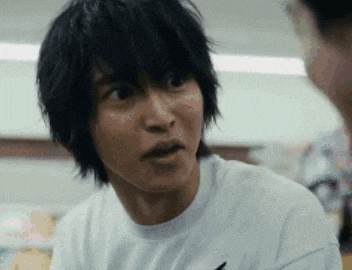 a close up of a man 's face with a surprised look on his face