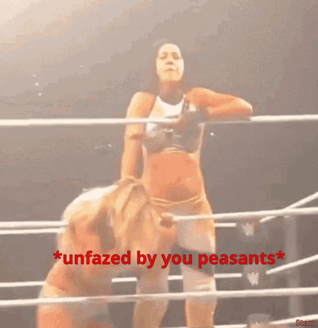 a woman in a wrestling ring with the words * unfazed by you peasants * above her