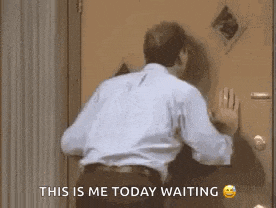 a man is standing in front of a door with his hand on it and says `` this is me today waiting '' .