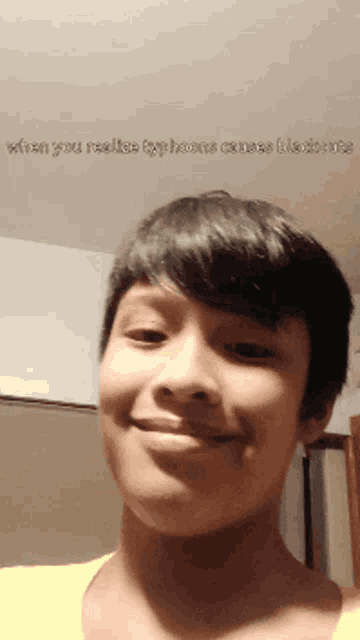 a young boy smiles in front of a screen that says " when you realize typhoons cause blockages "