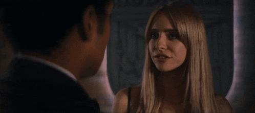 a man and a woman are looking at each other