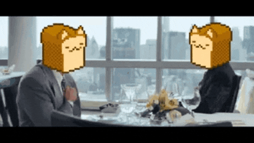 a man in a suit and tie is sitting at a table with a sandwich on his head .