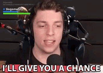 a man wearing headphones says i 'll give you a chance in front of a microphone