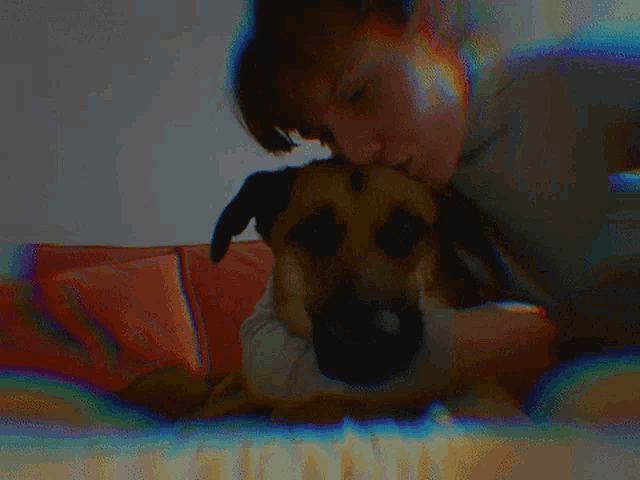 a man is petting a dog on a couch with a blurry background