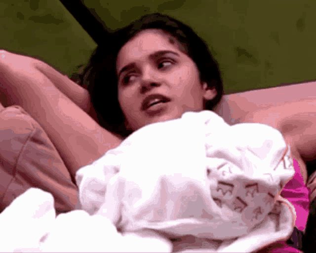 a woman laying on a couch with a white blanket that says ' i 'm sorry ' on it