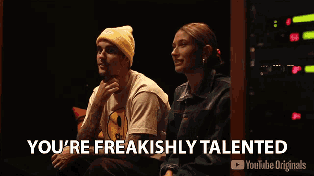 a man and a woman are sitting next to each other with the words you 're freakishly talented