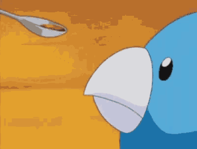a close up of a blue bird with a white beak and red beak .