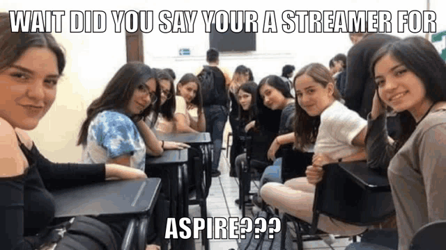 a group of girls are sitting at desks in a classroom with the caption wait did you say your a streamer