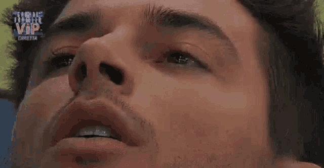 a close up of a man 's face with the word vip on the bottom left