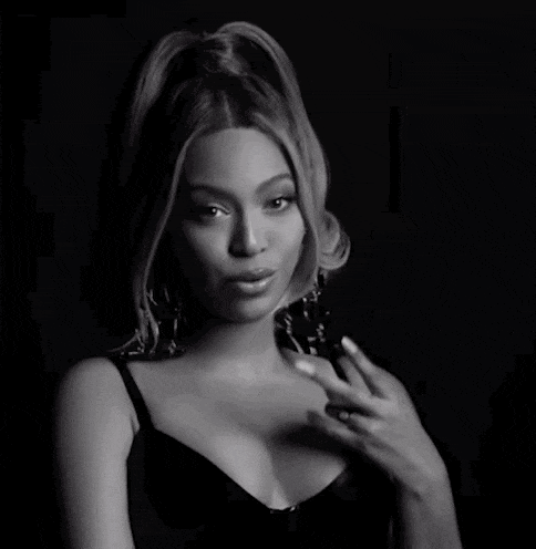 a black and white photo of a woman in a black bra