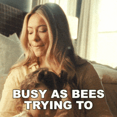 a woman holding a child with the words busy as bees trying to on the bottom
