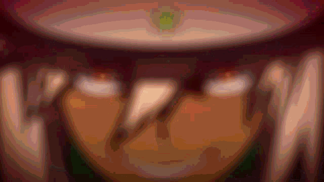 a close up of a person 's face with a blurred background