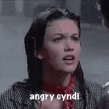 a close up of a woman 's face with the words `` angry cyndi '' written next to her .