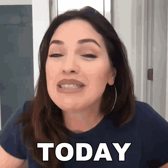 a woman in a blue shirt says today in front of her face