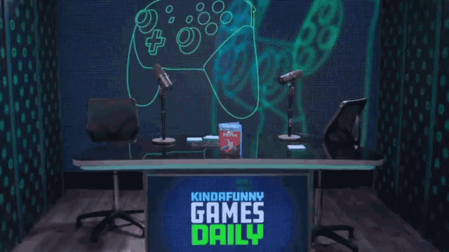 a kinda funny games daily studio with two microphones and a book on the table