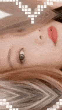 a close up of a woman 's face with a heart shaped border around it
