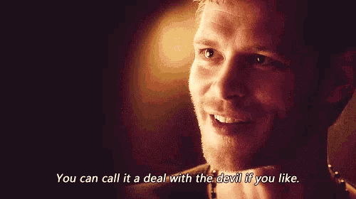 a man is smiling and saying " you can call it a deal with the devil if you like . "