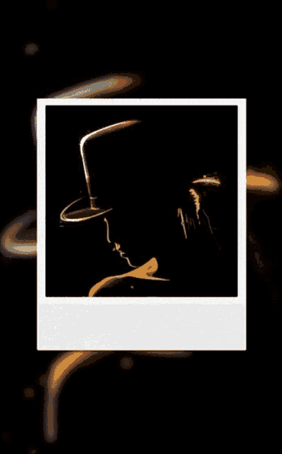 a silhouette of a man wearing a top hat and bow tie