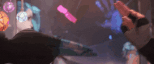 a blurry picture of a person holding a gun in a room with a purple background .