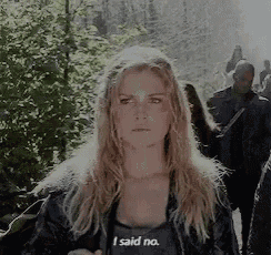 a woman is standing in front of a group of people and saying i said no .