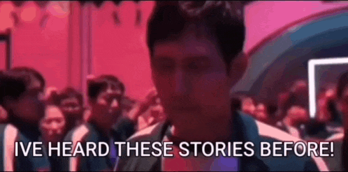 a man is standing in front of a crowd and says i 've heard these stories before