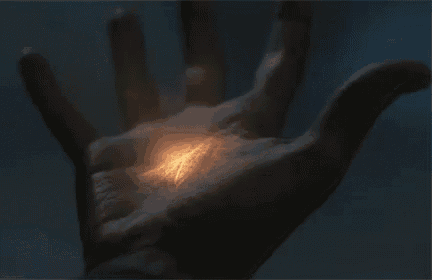 a close up of a hand with a light coming out of it .