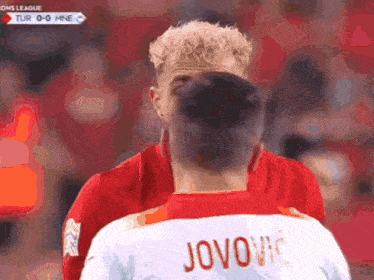 two soccer players one of whom has the name jokovic on his back