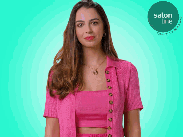 a woman in a pink top and pink cardigan is standing in front of a blue background with a salon line logo
