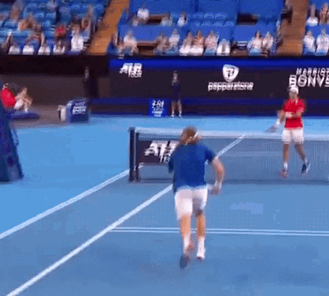 two men are playing tennis on a court with a banner that says pepperstone on it