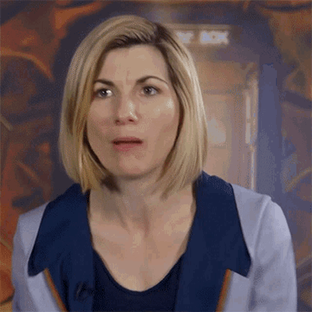a close up of a woman 's face with a shocked look on her face