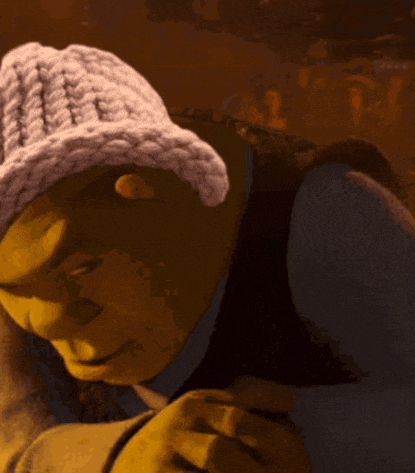 shrek is wearing a white knitted hat and looking down