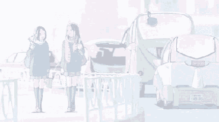 a couple of girls standing next to each other on the side of a street .