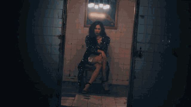 a group of women are dancing in a dark room with lights