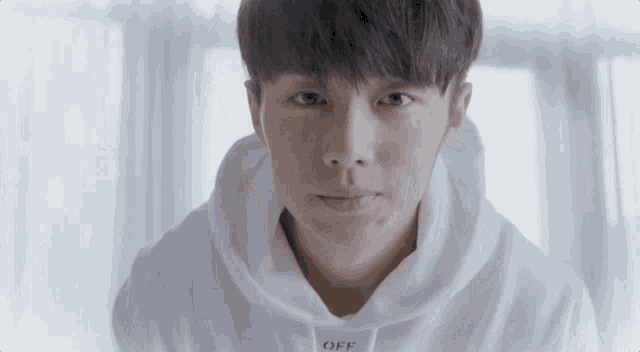 a young man wearing a white hoodie with the word off on the front