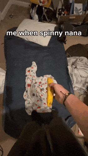 a person is holding a banana in front of a bed with the caption me when spinny nana
