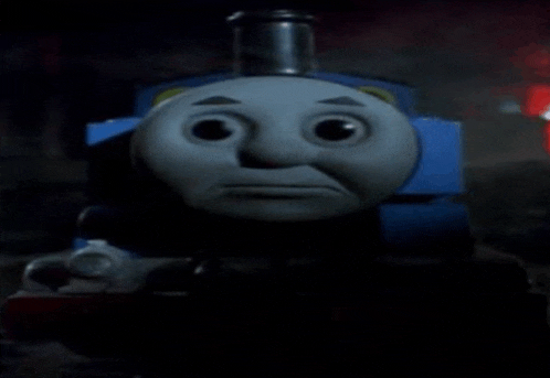 thomas the train is making a sad face in the dark .