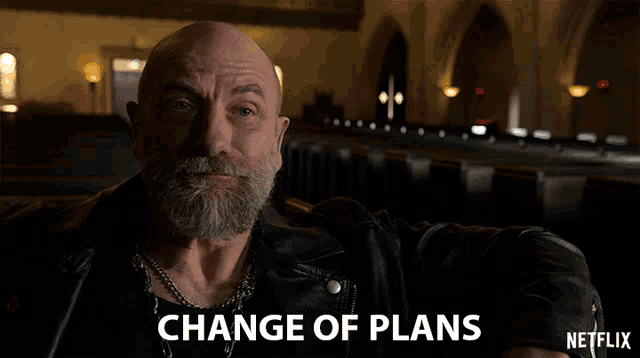 a man with a beard and a leather jacket says change of plans on a netflix ad