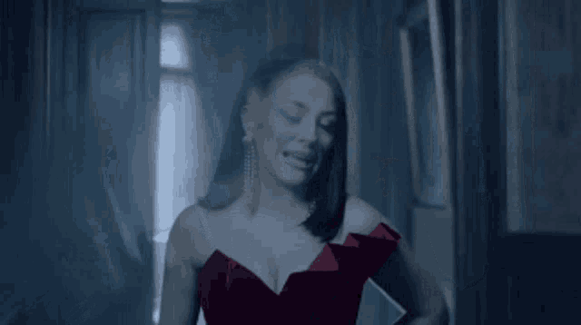 a woman in a red dress with a plunging neckline