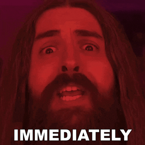 a man with long hair and a beard has the word immediately above his head