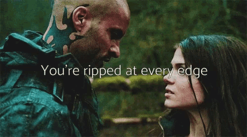 a man and a woman are looking at each other with the words " you 're ripped at every edge " written above them .