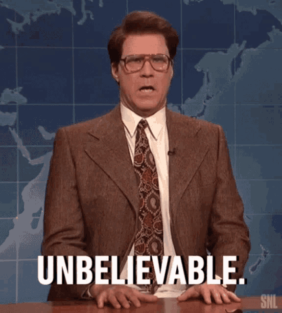 a man in a suit and tie is sitting at a table and says unbelievable .