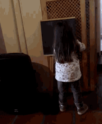 a little girl is standing in front of a blackboard that says api on it