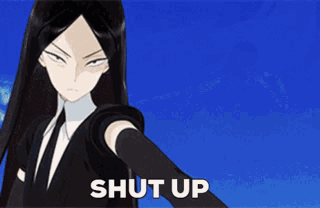 a woman in a suit and tie is holding a gun and says shut up .