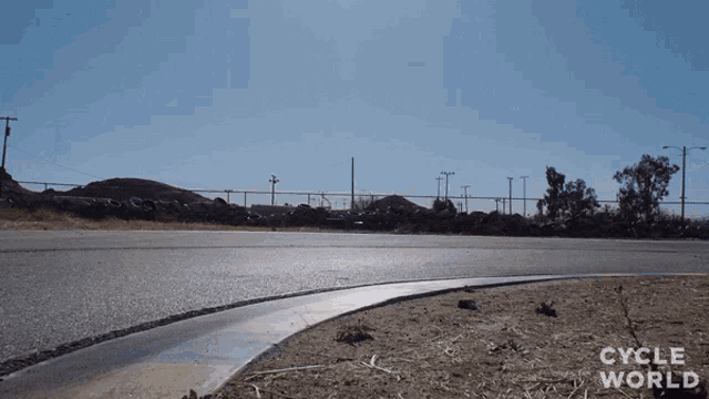 a road with the words cycle world on the bottom right