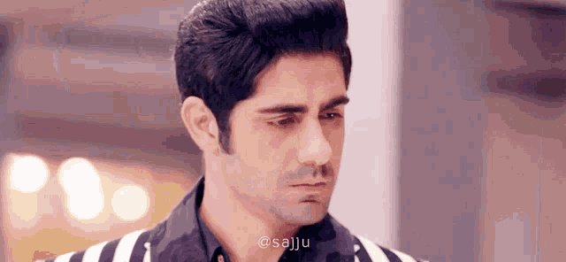 a close up of a man 's face with the words @sajju on the bottom left