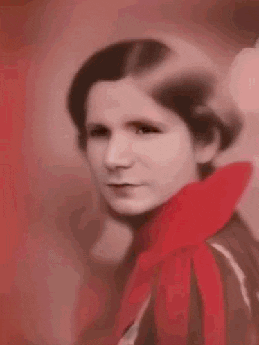 a black and white portrait of a young girl in a red dress .