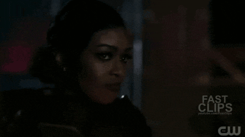 a close up of a woman 's face in a dark room .